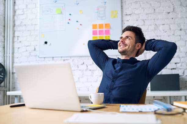 Founder leaning back from their desk, hands behind head, relaxed after clearing a security review
